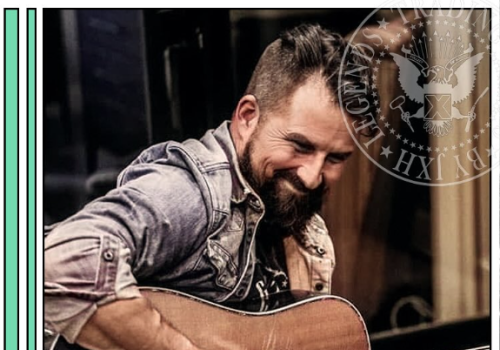 Man playing an acoustic guitar, smiling warmly, wearing a denim shirt; badge overlay reads &ldquo;Leigh Gilbert&rdquo; and &ldquo;Malpractice&rdquo; with guitar+vocals.